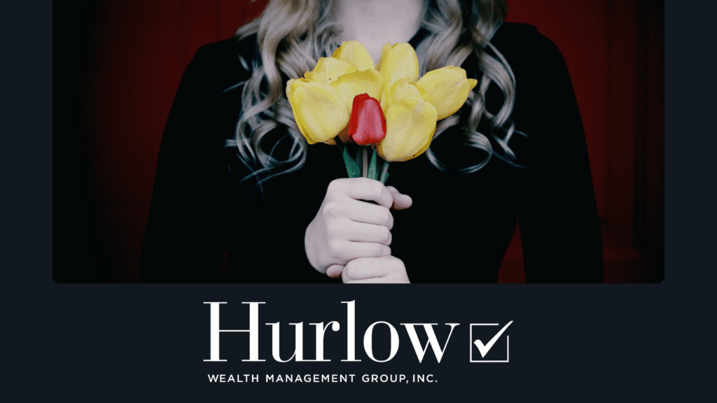 woman wearing black, holding flowers