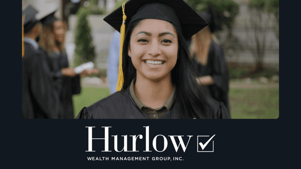 A young female graduate smiles at the camera in her graduation gown and hat